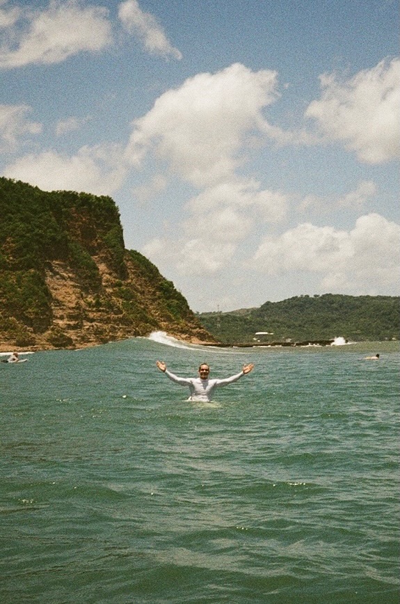 Surfer celebrating in the water with arms raised